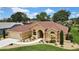 Inviting home featuring manicured landscaping, a spacious driveway, and a warm, welcoming facade at 9346 Southern Belle Dr, Weeki Wachee, FL 34613