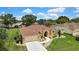 Beautiful home featuring a manicured lawn, an expansive driveway, and a warm, welcoming facade at 9346 Southern Belle Dr, Weeki Wachee, FL 34613
