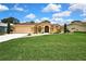 Charming single-story home featuring a well-manicured lawn and inviting curb appeal, perfect for a Gathering at 9346 Southern Belle Dr, Weeki Wachee, FL 34613