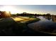 Expansive golf course with early morning sunlight reflecting off a tranquil lake, showcasing natural beauty at 9346 Southern Belle Dr, Weeki Wachee, FL 34613