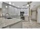 Modern kitchen with granite countertops, stainless steel appliances, and ample cabinet space at 9346 Southern Belle Dr, Weeki Wachee, FL 34613