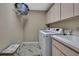 Laundry room with washer and dryer and storage cabinets at 9346 Southern Belle Dr, Weeki Wachee, FL 34613