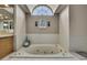 Bright bathroom with soaking tub, natural light and white tile surround at 9346 Southern Belle Dr, Weeki Wachee, FL 34613