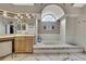 Luxurious main bathroom with a soaking tub, custom tile work, and a large window at 9346 Southern Belle Dr, Weeki Wachee, FL 34613