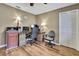 Office with wood-look floors, desk, chairs, and overhead lamp lighting at 9346 Southern Belle Dr, Weeki Wachee, FL 34613