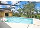 Relaxing screened-in pool with inviting cool blue water and a glimpse of the serene backyard at 9346 Southern Belle Dr, Weeki Wachee, FL 34613