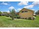 Landscaped backyard with a view of the screened pool, offering a private and serene retreat at 9346 Southern Belle Dr, Weeki Wachee, FL 34613