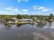 Aerial view of a waterfront home with a private dock on a sunny day at 100 18Th Nw St, Ruskin, FL 33570