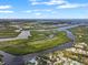 Stunning aerial view of winding waterways, lush islands, and waterfront homes under a cloudy blue sky at 100 18Th Nw St, Ruskin, FL 33570