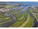 Beautiful aerial view showcasing winding waterways, vibrant islands, and a distant boat at 100 18Th Nw St, Ruskin, FL 33570