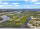 Panoramic aerial view of lush islands surrounded by winding waterways and blue skies at 100 18Th Nw St, Ruskin, FL 33570