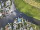 Overhead shot of waterfront homes, boat docks, and scenic waterway with lush green surroundings at 100 18Th Nw St, Ruskin, FL 33570