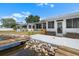 Backyard featuring a cement patio, lush landscaping, and waterfront access at 100 18Th Nw St, Ruskin, FL 33570