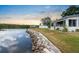 Picturesque waterfront backyard with lush lawn and seawall, ideal for relaxation and outdoor activities at 100 18Th Nw St, Ruskin, FL 33570