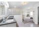 Elegant bathroom with glass block shower, soaking tub, updated vanity with plenty of counter space at 100 18Th Nw St, Ruskin, FL 33570