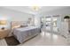 Bright bedroom with a queen size bed and access to the outdoor patio through french doors at 100 18Th Nw St, Ruskin, FL 33570