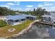 Waterfront home featuring a metal roof, boat dock, and spacious outdoor area at 100 18Th Nw St, Ruskin, FL 33570