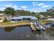 Waterfront home featuring a metal roof, boat dock, and spacious outdoor area at 100 18Th Nw St, Ruskin, FL 33570