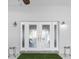 Elegant front porch with a decorative door, stylish lighting, and charming accents creating a welcoming entrance at 100 18Th Nw St, Ruskin, FL 33570