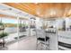 Elegant white kitchen with modern appliances, island seating, and a stylish wood ceiling at 100 18Th Nw St, Ruskin, FL 33570