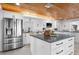 Spacious kitchen with stainless steel appliances, white cabinets, and a large center island at 100 18Th Nw St, Ruskin, FL 33570