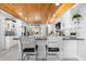 Bright kitchen with white cabinets, granite countertops, wood ceiling, and stainless steel appliances at 100 18Th Nw St, Ruskin, FL 33570