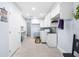 Bright laundry room featuring white cabinets, a sink, a washer, and a dryer at 100 18Th Nw St, Ruskin, FL 33570