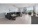 Bright and open living room with tile flooring, comfy seating, modern decor, and water views at 100 18Th Nw St, Ruskin, FL 33570
