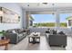 Bright living room featuring comfortable seating and large windows with serene water views at 100 18Th Nw St, Ruskin, FL 33570