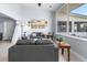 Open living room with vaulted ceiling and large windows showcasing the waterfront view at 100 18Th Nw St, Ruskin, FL 33570