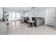 Spacious living room with modern decor, large sectional, tile flooring, and doors leading to the outdoors at 100 18Th Nw St, Ruskin, FL 33570