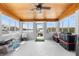 Enclosed patio featuring wood paneled ceiling, large windows with waterfront views, and access to boat dock at 100 18Th Nw St, Ruskin, FL 33570