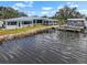 Tranquil waterfront home featuring a boat dock and beautifully landscaped shoreline at 100 18Th Nw St, Ruskin, FL 33570