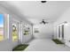 Bright and airy sunroom featuring lots of natural light, ceiling fan, and entry to the outdoor area at 100 18Th Nw St, Ruskin, FL 33570