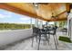 Sunroom with a wood-planked ceiling, floor to ceiling windows, and a waterfront view at 100 18Th Nw St, Ruskin, FL 33570