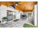 Sunroom featuring a wood-planked ceiling, floor to ceiling windows, and a waterfront view at 100 18Th Nw St, Ruskin, FL 33570