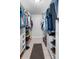 Well-organized walk-in closet with built-in shelving and storage, providing ample space at 100 18Th Nw St, Ruskin, FL 33570