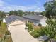 Aerial view of a home with a two-car garage and detached garage in a residential neighborhood at 1022 Chandler Snowden Ct, Ruskin, FL 33570