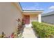 Inviting front porch with a decorative wreath and meticulously landscaped walkway at 1022 Chandler Snowden Ct, Ruskin, FL 33570