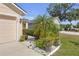 Home with a well-manicured front yard and a decorative palm tree at 1022 Chandler Snowden Ct, Ruskin, FL 33570