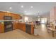 Open kitchen and living space with a kitchen island, black appliances, and living room furniture at 1022 Chandler Snowden Ct, Ruskin, FL 33570