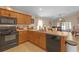 Open kitchen design with wood cabinets and stainless steel appliances at 1022 Chandler Snowden Ct, Ruskin, FL 33570