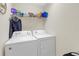 Functional laundry room equipped with a washer and dryer, plus shelving at 1022 Chandler Snowden Ct, Ruskin, FL 33570