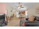Bright open-concept living room with tile floors, ceiling fan, and neutral walls at 1022 Chandler Snowden Ct, Ruskin, FL 33570