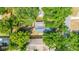 Aerial view of home showing property lines surrounded by mature trees and other residences at 1211 E Comanche Ave, Tampa, FL 33604