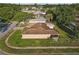 Aerial view of the home in a neighborhood setting, with mature trees and well-kept lawns at 12817 Lake Tree Ln, Hudson, FL 34669