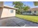 Spacious backyard with well-maintained lawn and patio with exterior storage building at 12817 Lake Tree Ln, Hudson, FL 34669