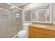 Bathroom features walk-in shower, vanity, and tile flooring for a calming neutral aesthetic at 12817 Lake Tree Ln, Hudson, FL 34669