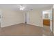 Bedroom features view to closet and bathroom with matching tile floor throughout at 12817 Lake Tree Ln, Hudson, FL 34669