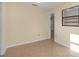 Bedroom featuring tiled floors and a built-in closet system for optimal storage at 12817 Lake Tree Ln, Hudson, FL 34669